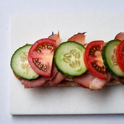 Sandwich with tomato and cucumber topping