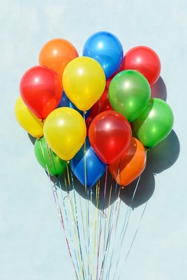 Colorful balloons against blue wall