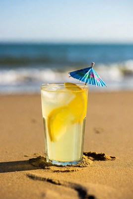 Refreshing drink on sandy beach