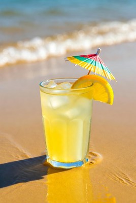 Lemon drink on beach sand