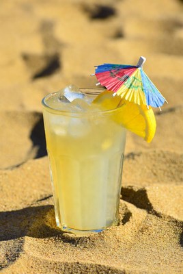 Refreshing drink on sandy beach