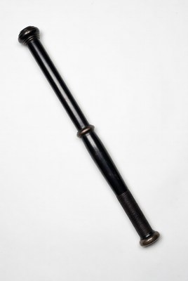 Turned ebony baton against white background