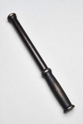 Black baton on white surface