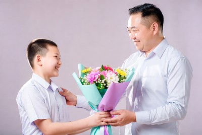 Father and son share flowers in celebration