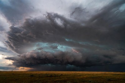 Storm clouds above open field