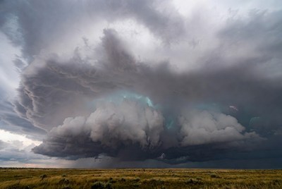 Dark clouds gather over open field