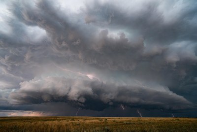 Storm clouds over open field