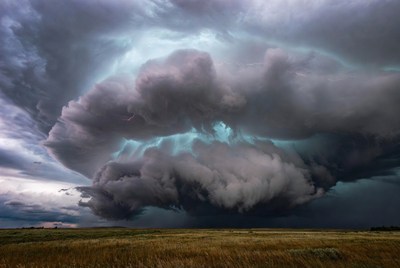 Storm clouds over open field
