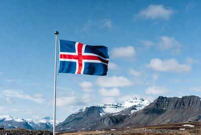 Icelandic flag flying against mountains