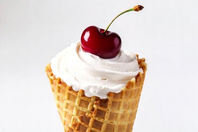 Delicious ice cream cone with cherry