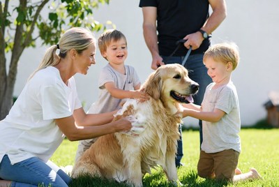 Kids playing with dog in backyard