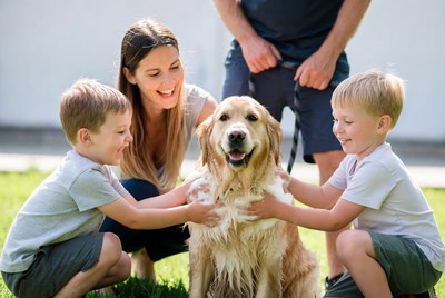 Family with dog in sunny yard
