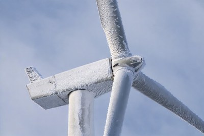 Wind turbine covered in frost on a winter day