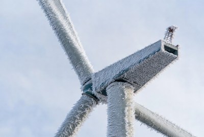 Wind turbine covered in frost during winter
