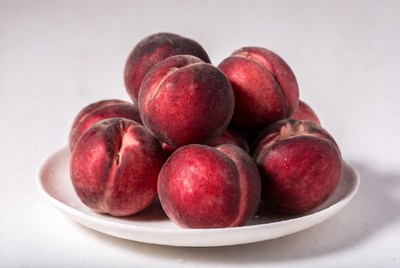 Fresh peaches on white plate