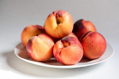 Fresh peaches on a white plate