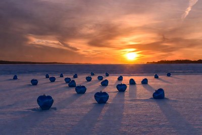 Hearts on the frozen lake at sunset