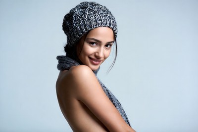 Woman in hat with scarf posing