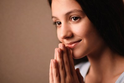 Girl with hands in prayer pose