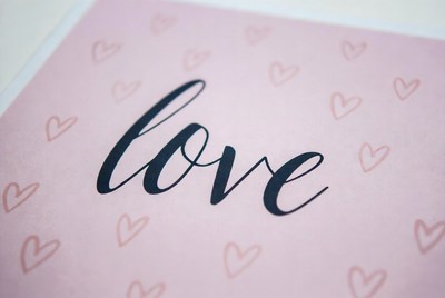 Love written on pink paper