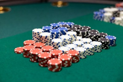 Stacked poker chips on green table