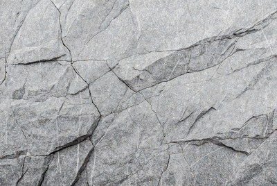 Texture of cracked gray stone surface