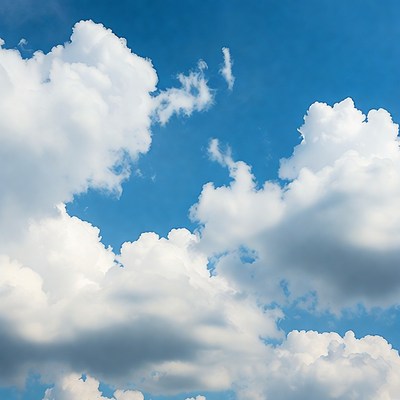 Clouds in a bright blue sky during midday