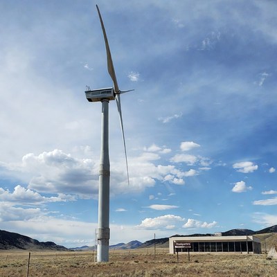 Wind turbine near the building in grassland