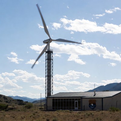 Wind turbine near building in landscape