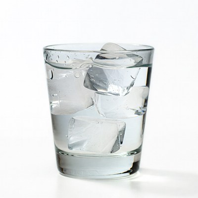 Cold water with ice cubes in glass