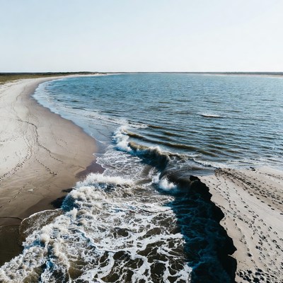 Waves meeting the shore at sunset