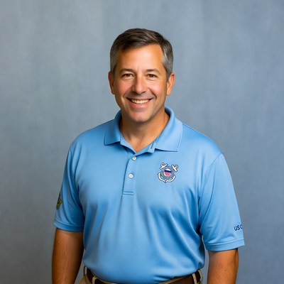 Man in blue shirt standing indoors