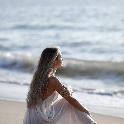 Woman sitting by the sea