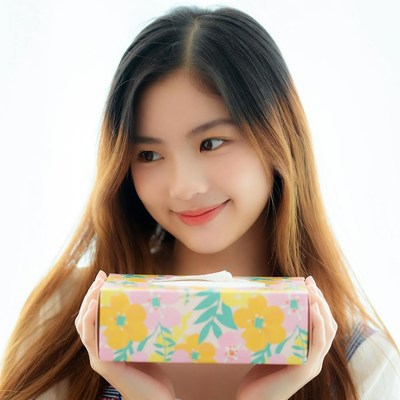 Smiling girl holding tissue box