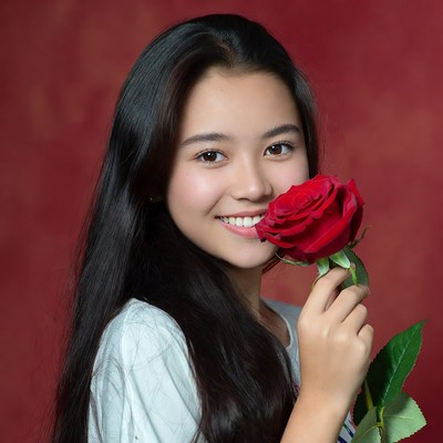 Young girl holding a red rose