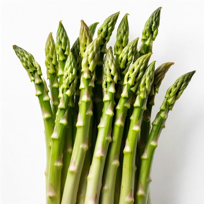 Fresh asparagus arranged neatly on a white surface