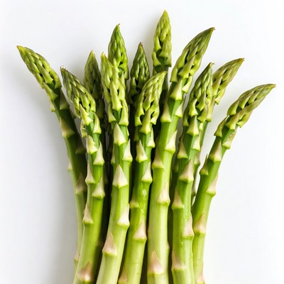 Fresh green asparagus stalks on a white surface
