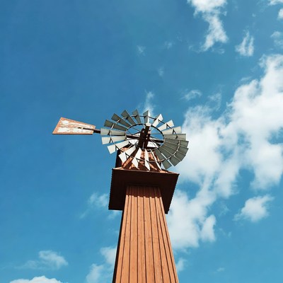 Windmill stands tall against blue sky
