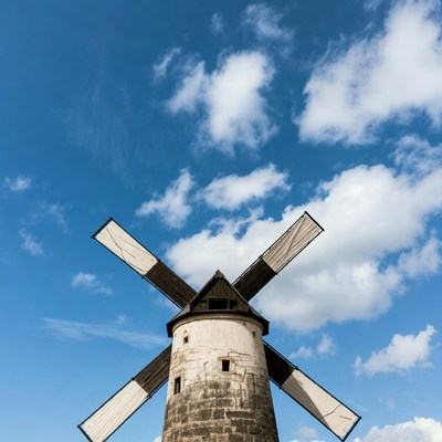 Windmill under blue sky and clouds