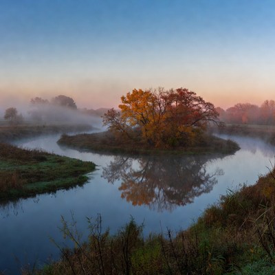 Foggy river scene at dawn