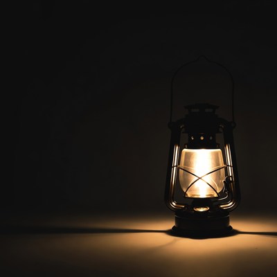 Old lantern lights up a dark room