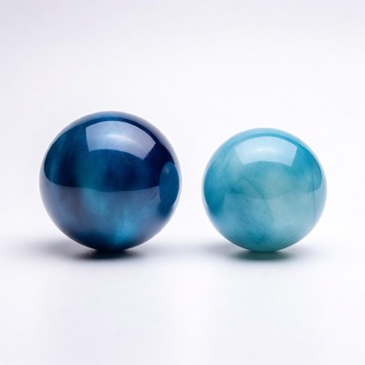 Two glass orbs on a white surface