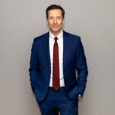 Man in a suit poses for camera