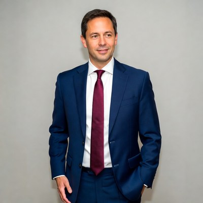 Man in suit poses for photo