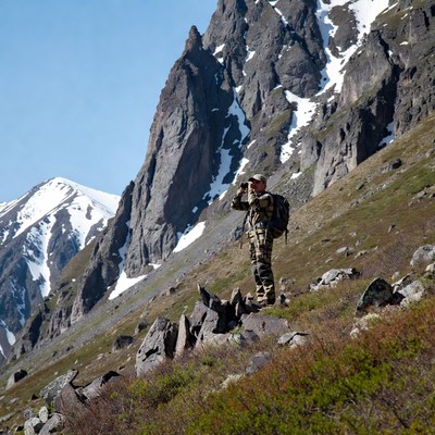Hunter surveys mountain landscape