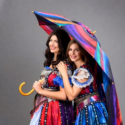 Two women under painted umbrella