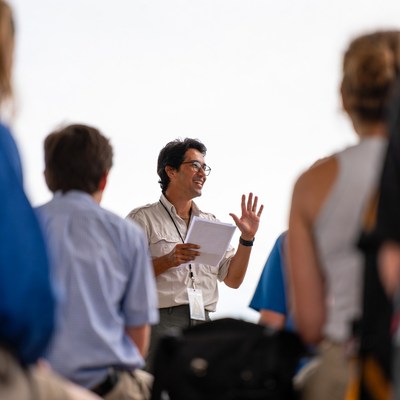 Group listening to a speaker in an outdoor setting