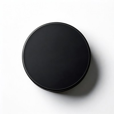 Simple black circular object on white surface