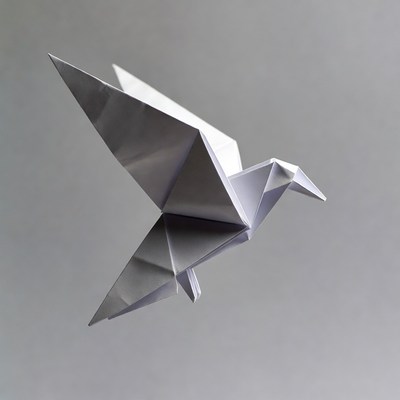 Silver origami bird in flight
