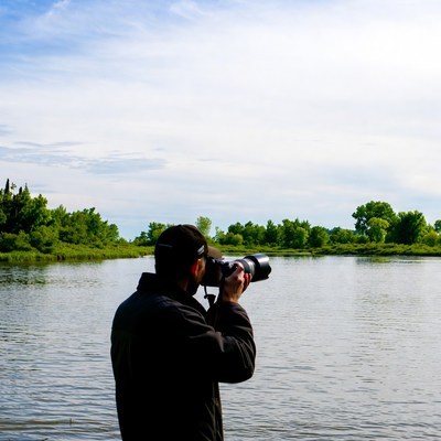 Man takes pictures by the river